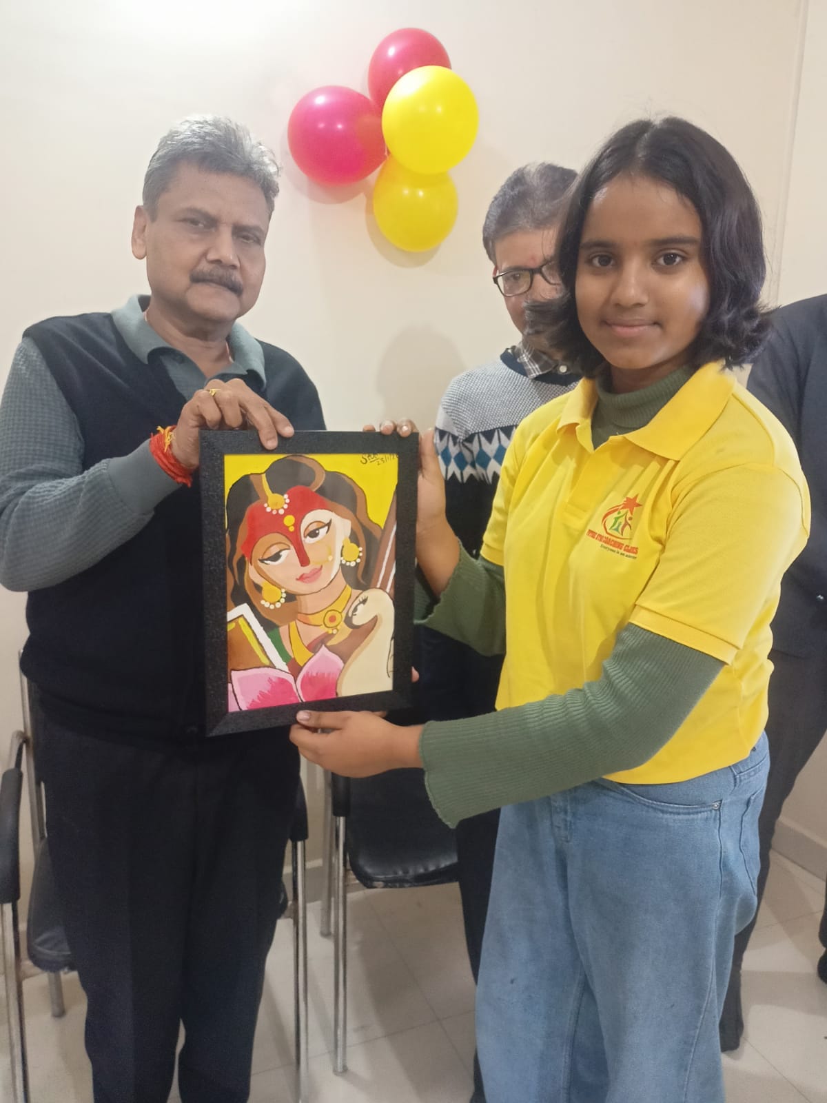 Student presents a framed painting with teachers