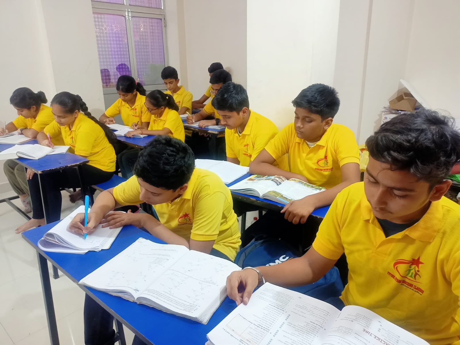 Students studying together at classroom desks